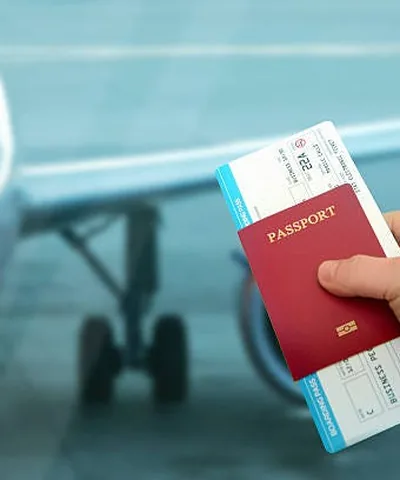 Traveller holding passport and flight tickets